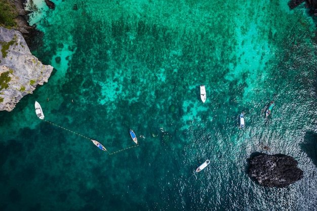 Hi season boat and tourists on phiphi island Krabi Thailand aerial view from drone 