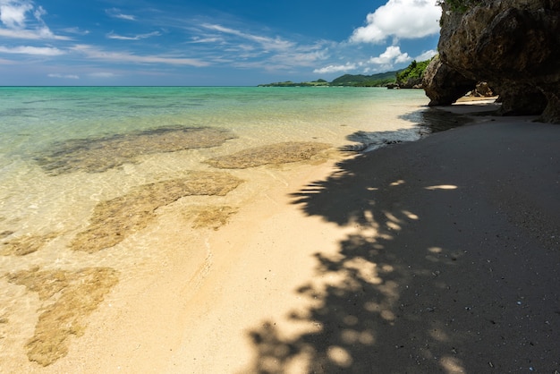 Hidden beach with emerald green sea, light and shadow sands.