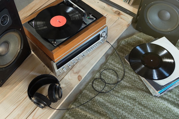 HiFi system with turntable amplifier headphones and lp vinyl records in a listening room