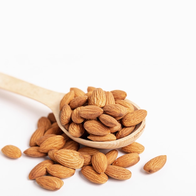 High angle of almonds in spoon with copy space