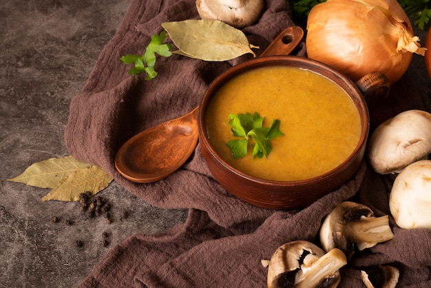 High angle arrangement with pumpkin soup and spoon