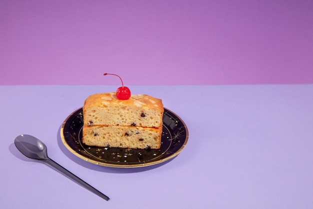 High angle cake with cherry on plate