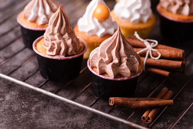 High angle of delicious cupcakes with cinnamon sticks