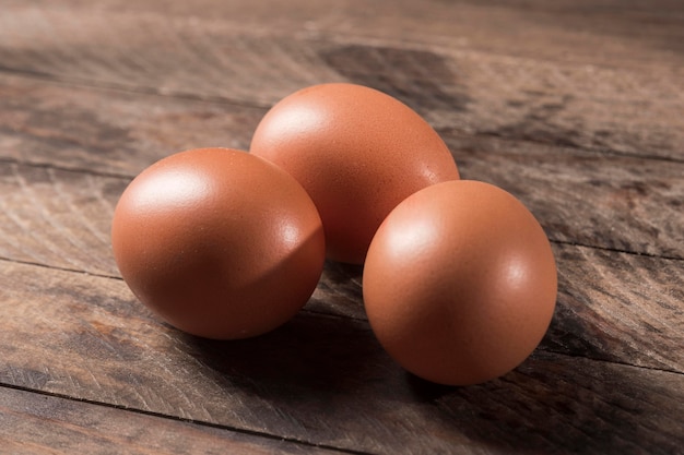 High angle eggs on wooden background