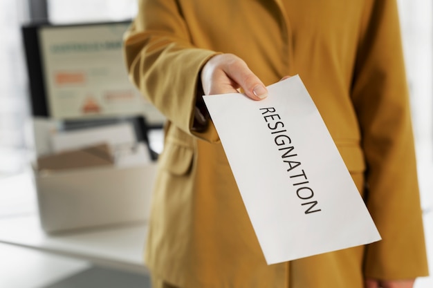 High angle employee holding resignation note