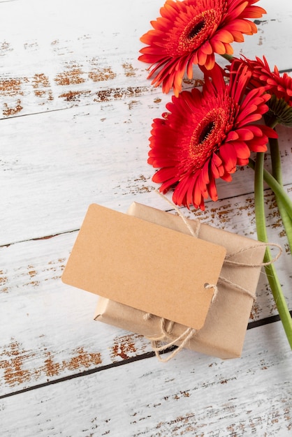 High angle of flowers with gift and tag