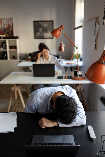 High angle frustrated man at work