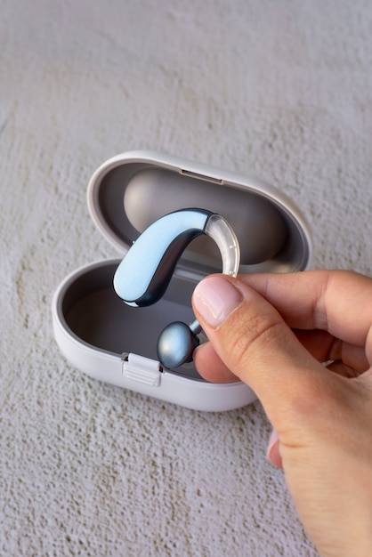 High angle hand holding hearing aids