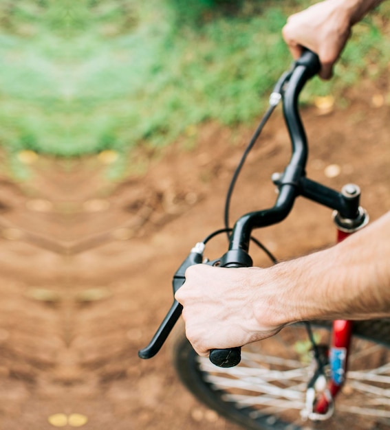 High angle of hands on bicycle handlebars Side view of hands on bicycle handlebars Concept of cyclist's hands on the handlebars