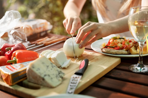 High angle hands cutting cheese