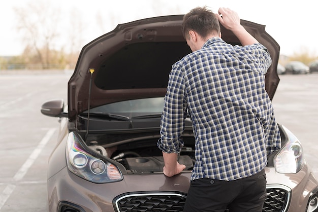 High angle man checking car