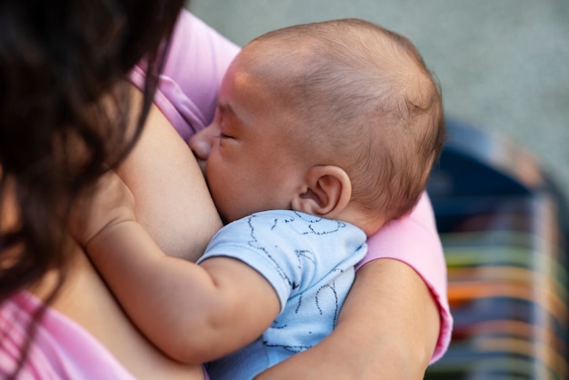 High angle mother breastfeeding baby