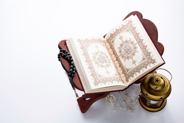 High angle opened quran next to candle 