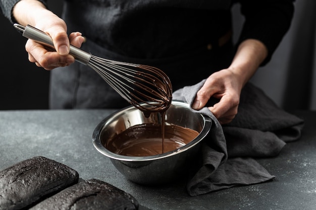 High angle of pastry chef preparing chocolate cake