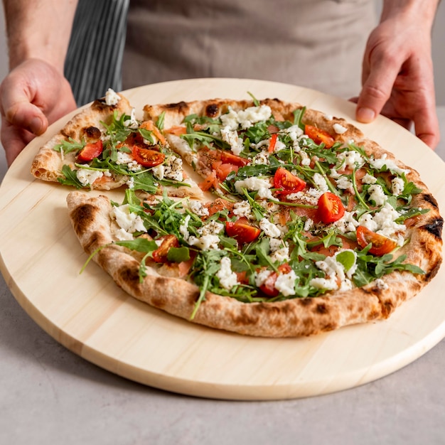 High angle person grabbing fresh pizza slice