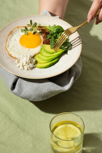 High angle of plate with keto diet food and a glass of water with lemon