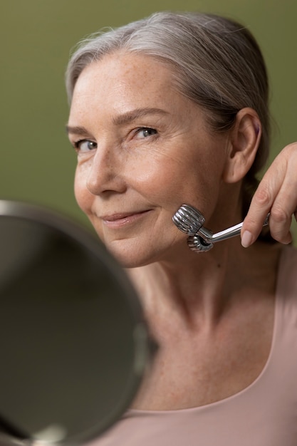 High angle senior woman massaging face