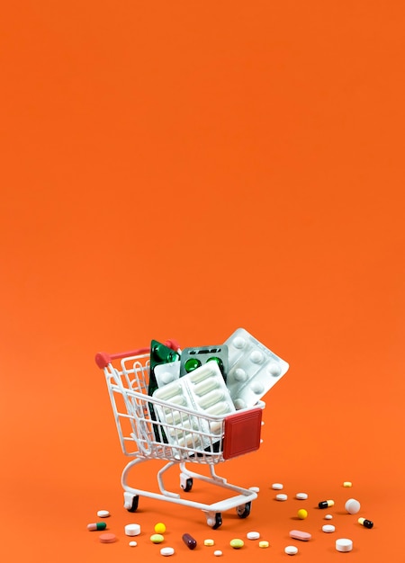 High angle of shopping cart with copy space and pill foils