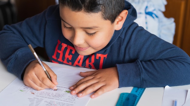 High angle shot of a Hispanic child studying at home