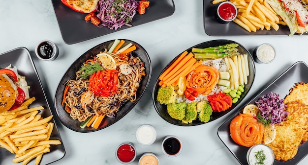 High angle shot of plates of colorful and traditional Japanese food on a table