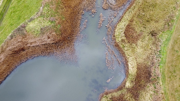 High angle shot of a river in the forest in Blakeney, Norfolk, UK