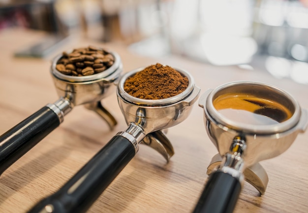 High angle of three coffee machine cups with different stages of coffee