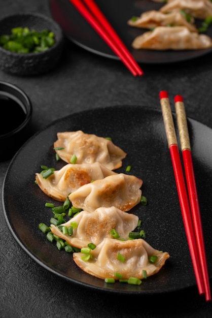 High angle of traditional asian dish with chopsticks and dumplings