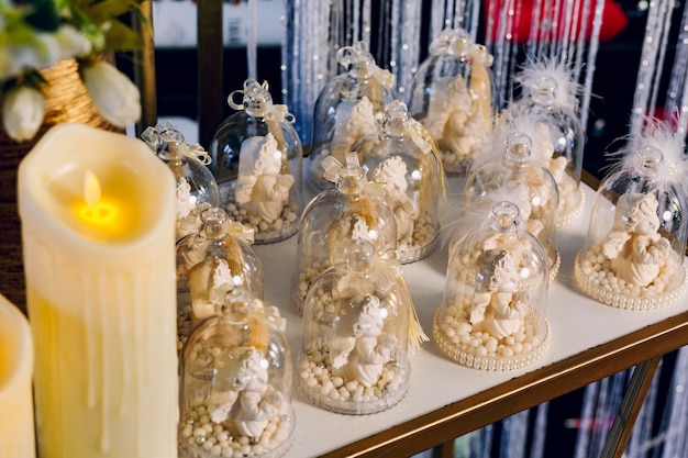 High angle view of angel souvenirs and artificial candles during the christening ritual