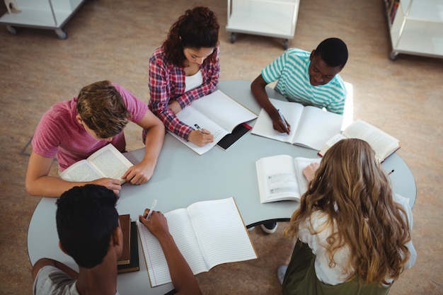 High angle view of attentive classmates studying in library