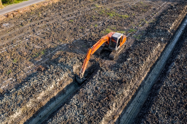 High angle view backhoe is dingging the groove garden and agricultural area Thailand 