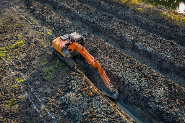 High angle view backhoe is dingging the groove garden and agricultural area Thailand 