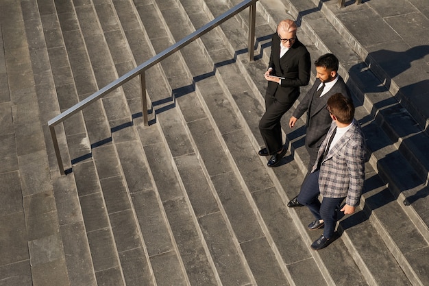 High angle view of business team moving down the stairs together in the city