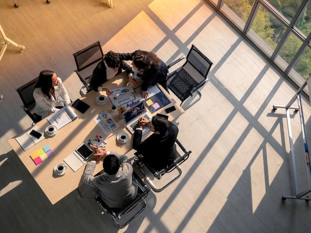 High angle view of business woman advise patner with empathy during meeting session in office, diversity business people, financial discuassion, good relationship in work place