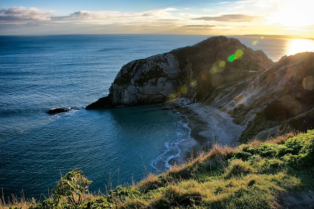 High angle view of cliff by sea against sky