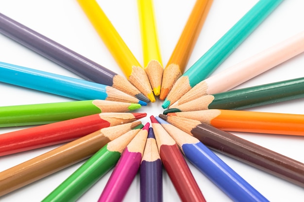 High angle view of colored pencils on white background