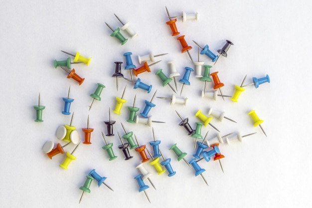 Photo high angle view of colorful thumbtacks against white background