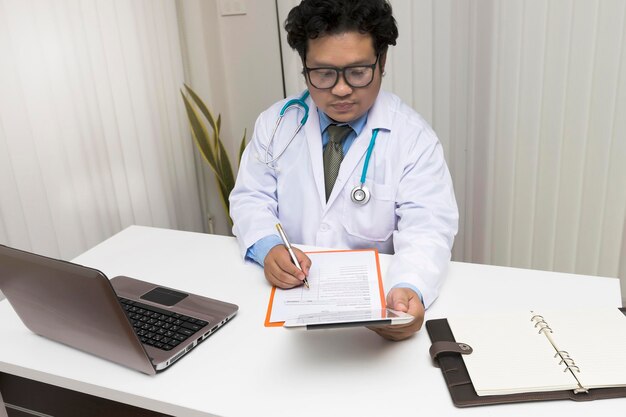 High angle view of doctor working at desk in hospital