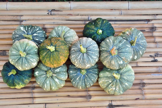 High angle view of group pumpkin on bamboo table