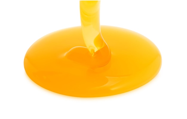 High angle view of honey pouring against white background