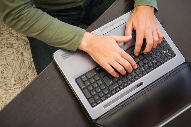 High angle view of a man typing on laptop 