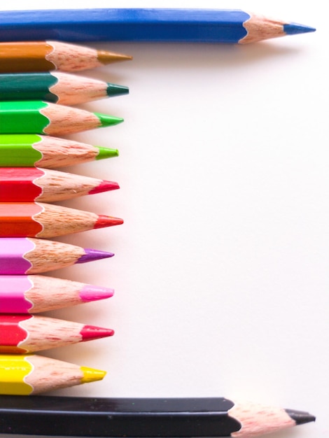 High angle view of multi colored pencils against white background