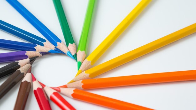 High angle view of multi colored pencils on white background