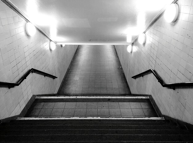 High angle view of steps in illuminated subway station