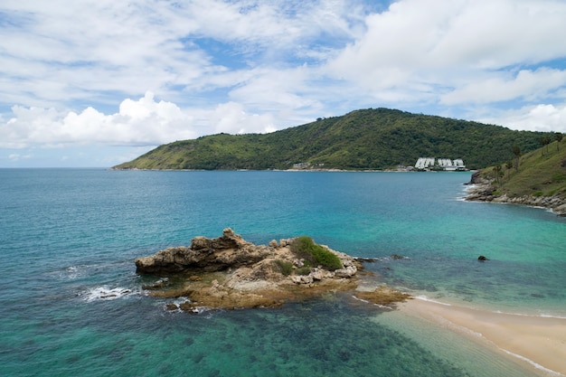 High angle view Tropical sea with wave crashing on seashore and high mountain located in Phuket Thailand aerial view drone top down Amazing nature view landscape Beautiful sea surface.