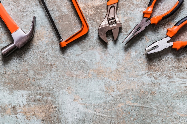 High angle view of various worktools on old wooden desk