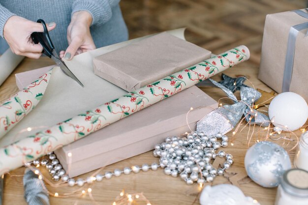 High angle view of woman wrapping christmas gift