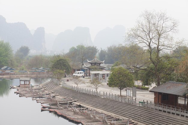 High angle view of wooden rafts moored in river against clear sky