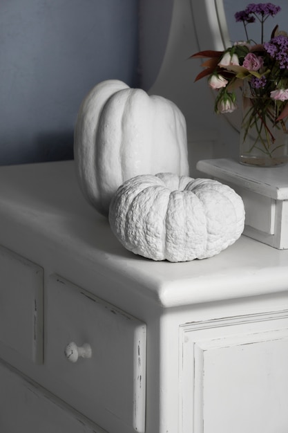 High angle white pumpkins and flowers