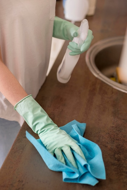 High angle of woman cleaning kitchen surface