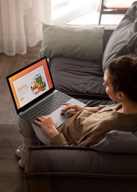 High angle woman holding laptop